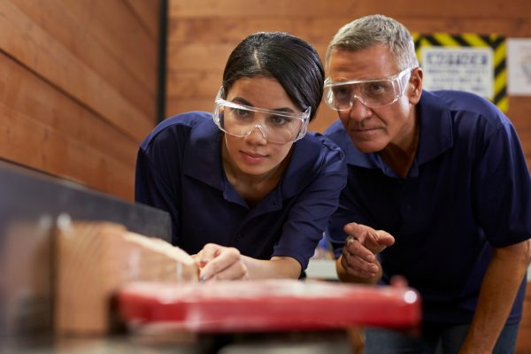 girl with goggles on being trained in work-based environment